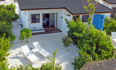Sun loungers on a private sandy patio at Joy Island