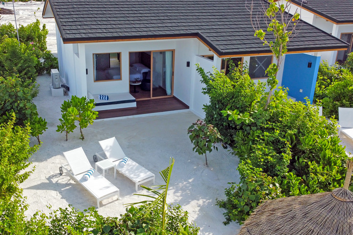 Sun loungers on a private sandy patio at Joy Island