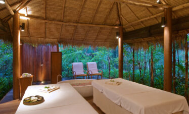 The Sarojin Khao Lak open-air spa room with nature views and treatment tables in a tranquil setting