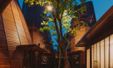 Unique wooden architecture illuminated at night at The Tubkaak Krabi