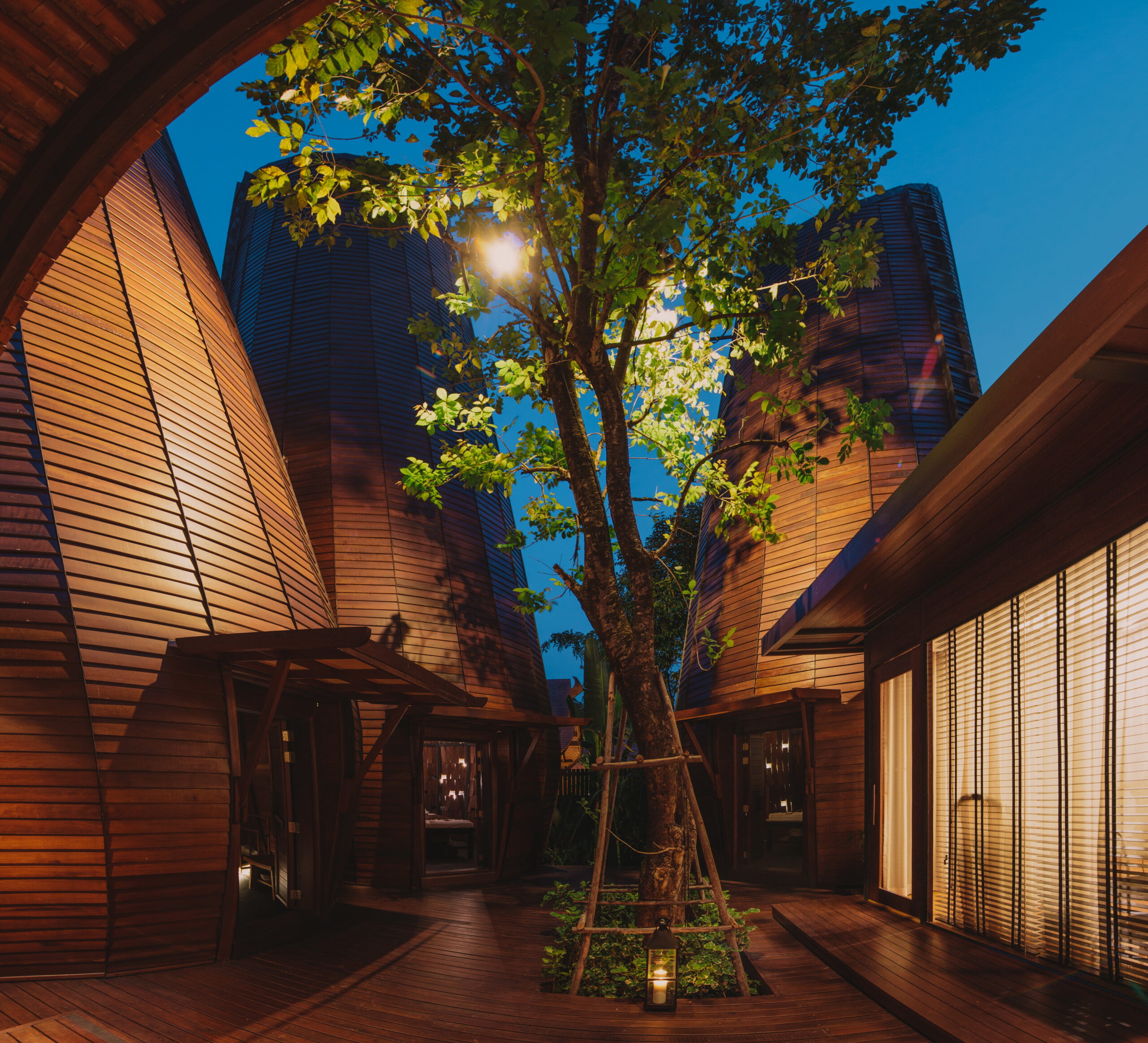 Unique wooden architecture illuminated at night at The Tubkaak Krabi