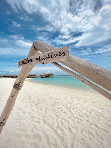 You and Me by Cocoon Maldives sign on the beach with clear blue sky