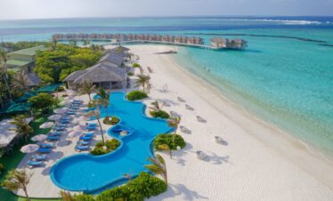 You and Me by Cocoon resort pool and beach area with overwater villas in view