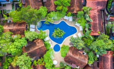 Aerial view of The Tubkaak Krabi pool surrounded by lush greenery and villas