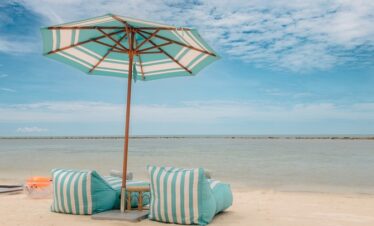 Beach chairs and umbrella on Marasca Samui sandy shore