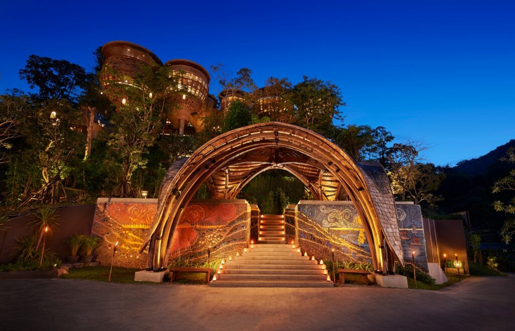 Beautiful entrance with archway and lit stairs leading into Keemala at night