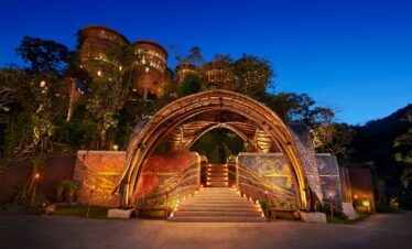 Beautiful entrance with archway and lit stairs leading into Keemala at night
