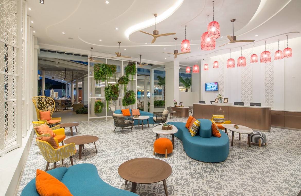 Centara lobby with vibrant seating and lush indoor greenery