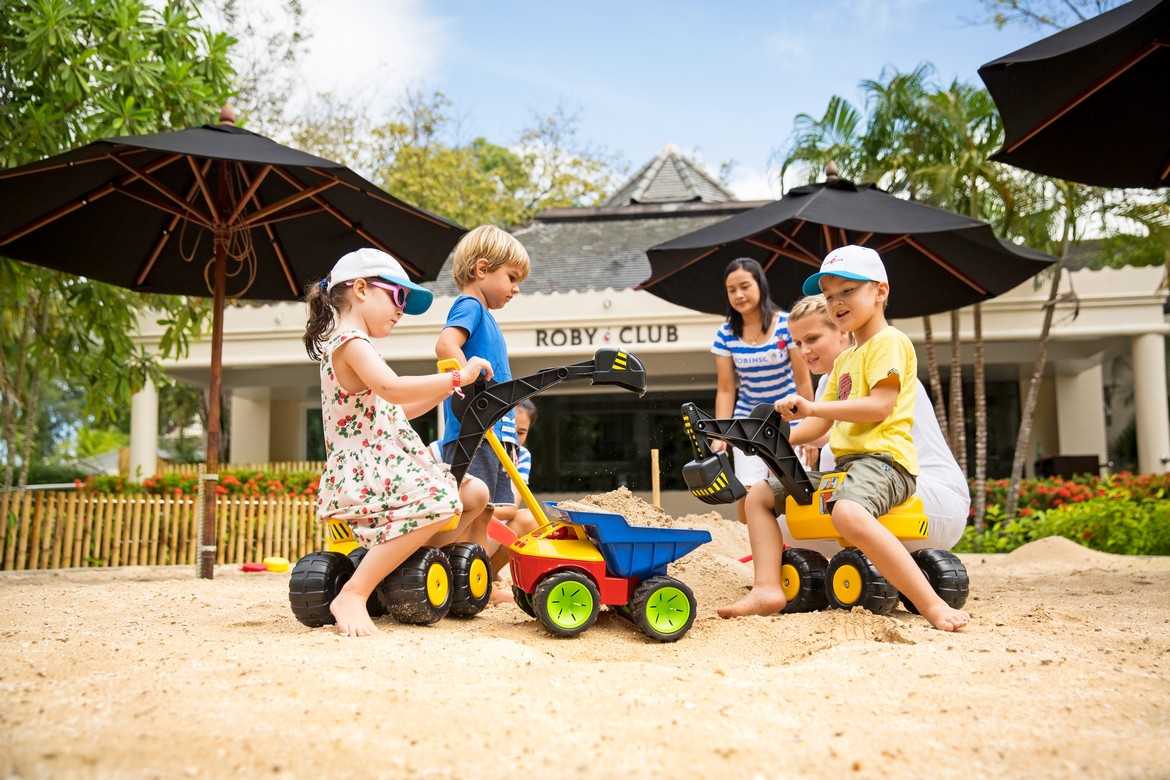 Children playing in the sand at Robinson Khao Lak