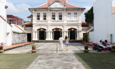 Couple walking into a historic museum near Saii Laguna with colonial architecture