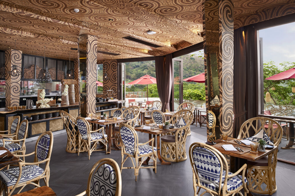 Cozy restaurant with intricate patterns on the walls and natural lighting at Keemala