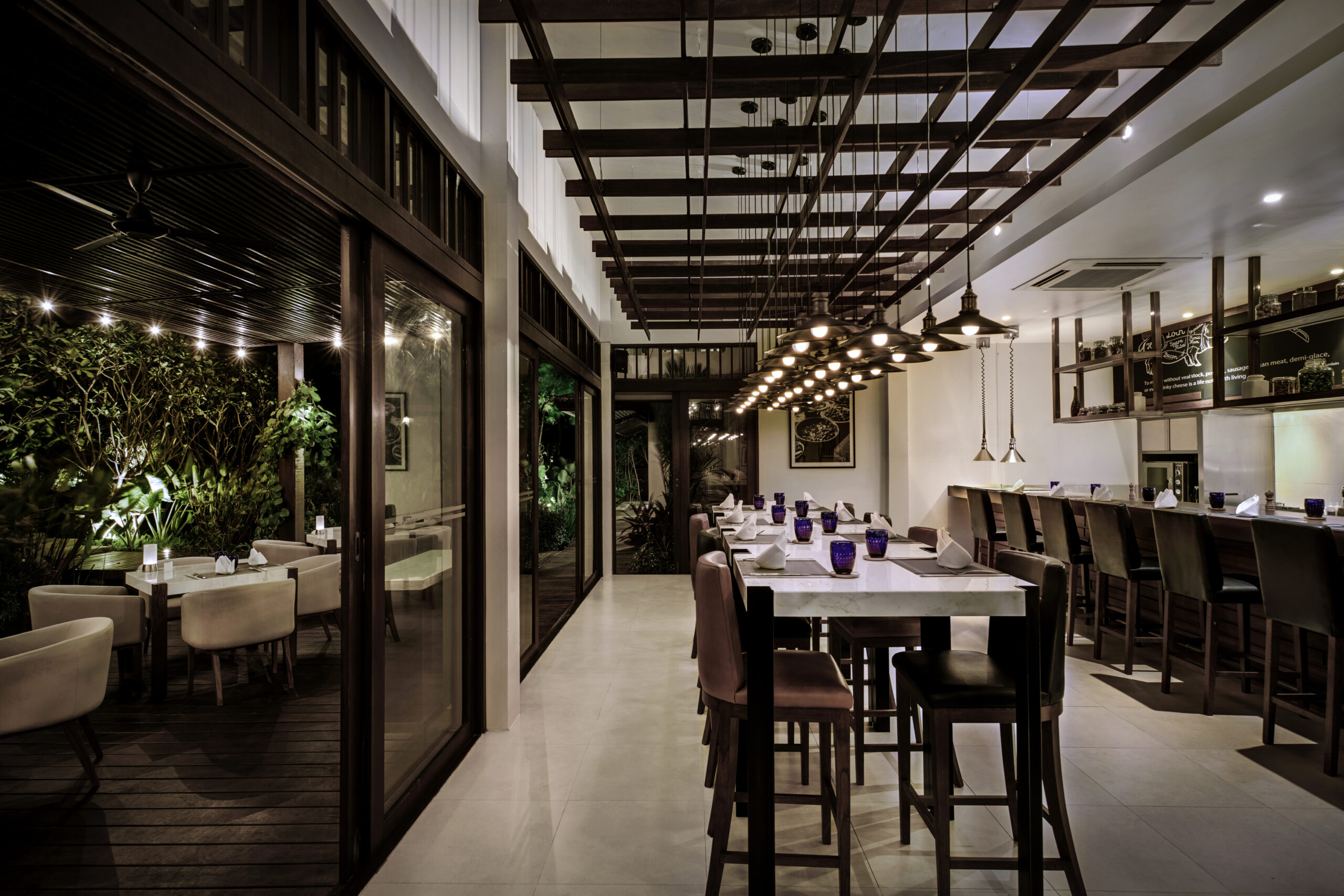 Elegant indoor dining space at Saii Koh Samui with modern decor and warm ambient lighting