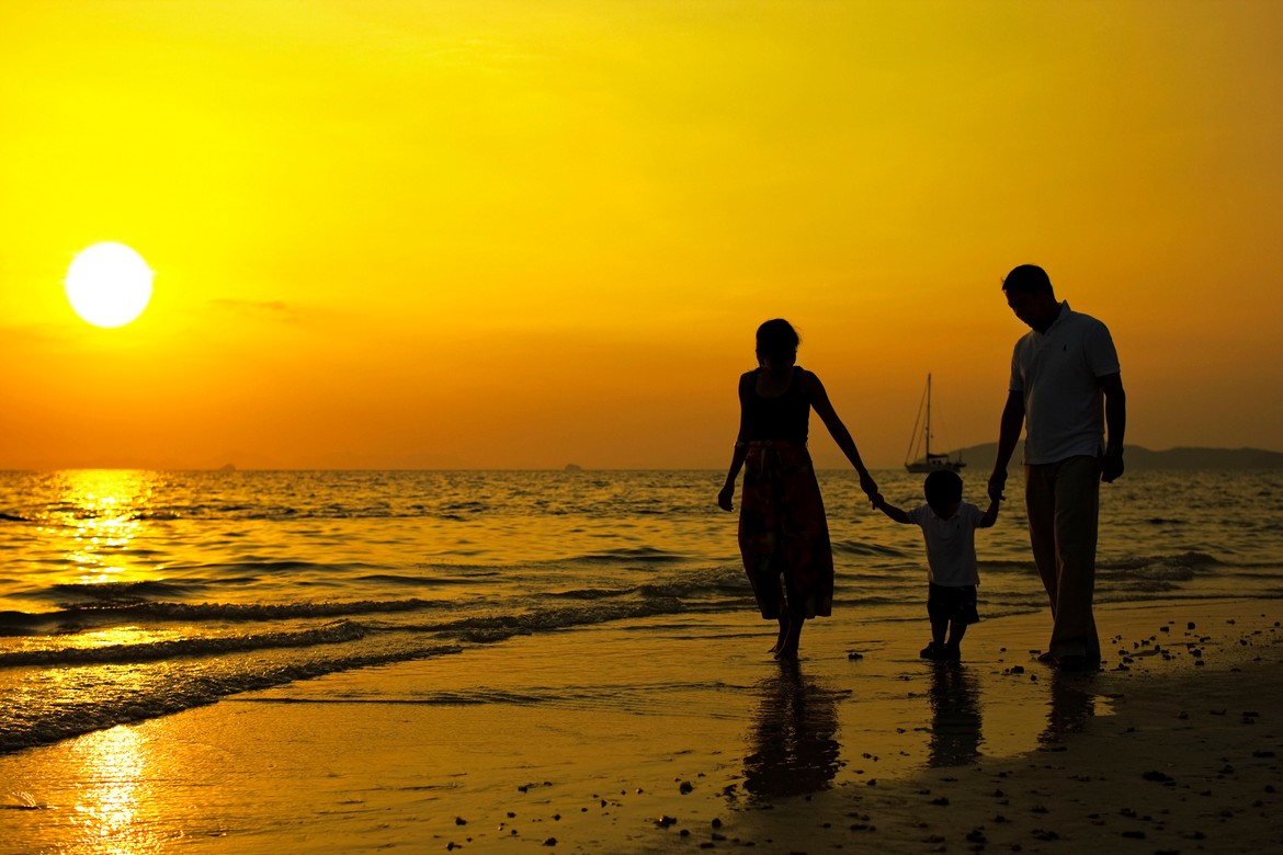Family walking on the beach during sunset at Rayavadee Krabi