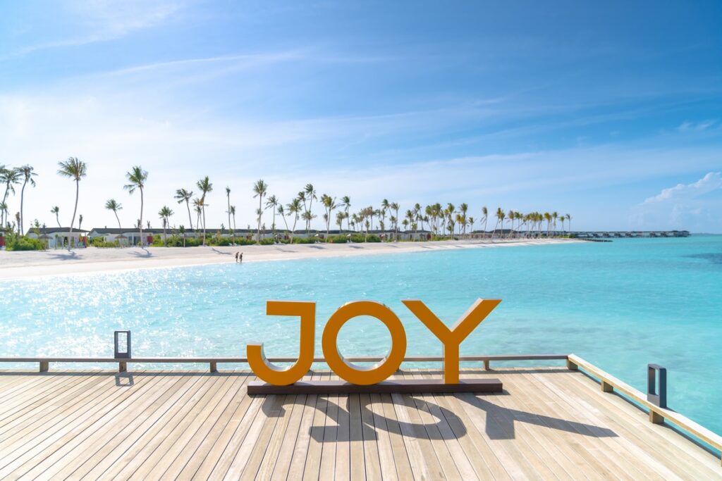 Joy Island sign on a wooden deck