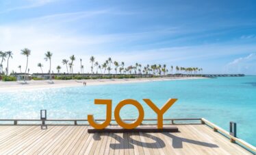 Joy Island sign on a wooden deck