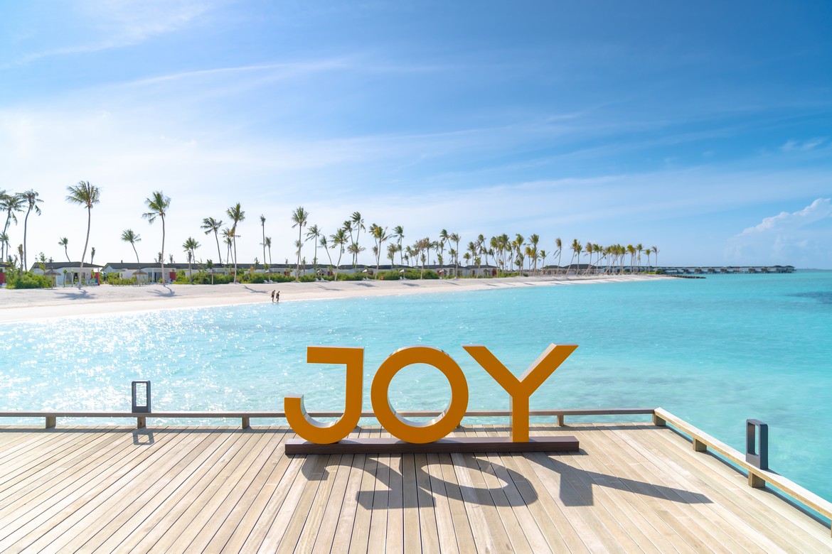 Joy Island sign on a wooden deck