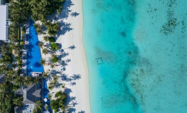 Kandima beach lined with palm trees and clear waters