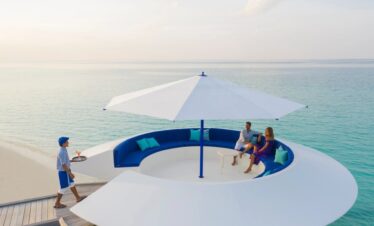 Kandima beachfront with poolside umbrellas and turquoise sea