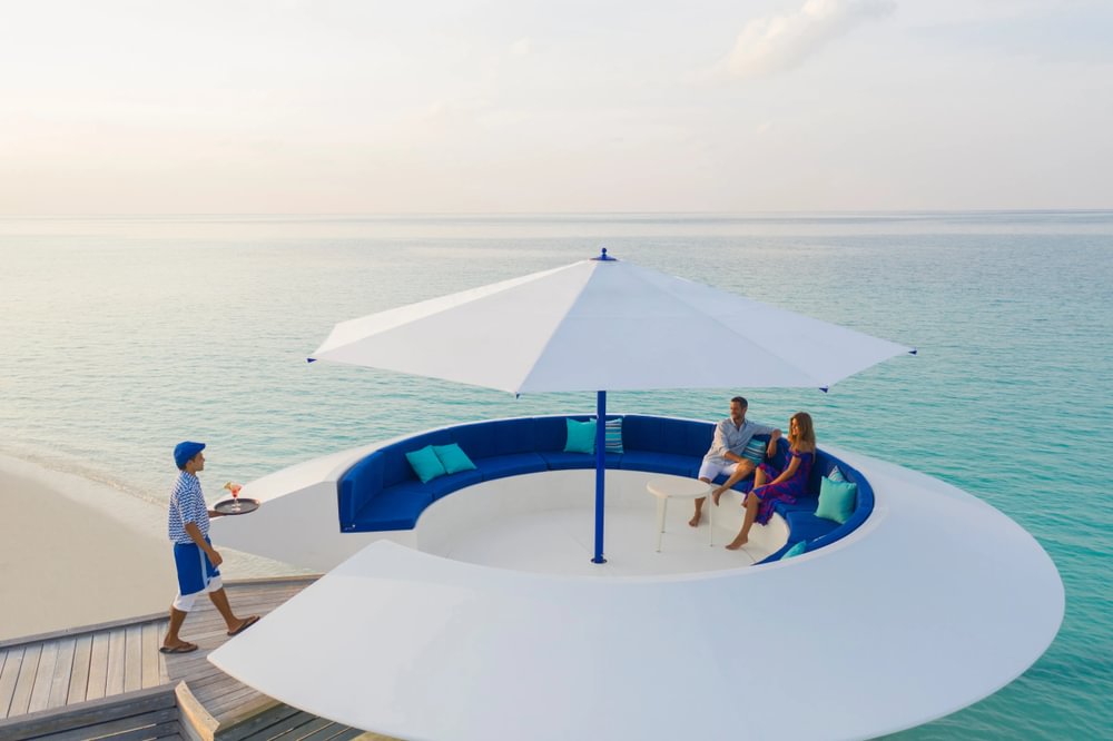 Kandima beachfront with poolside umbrellas and turquoise sea