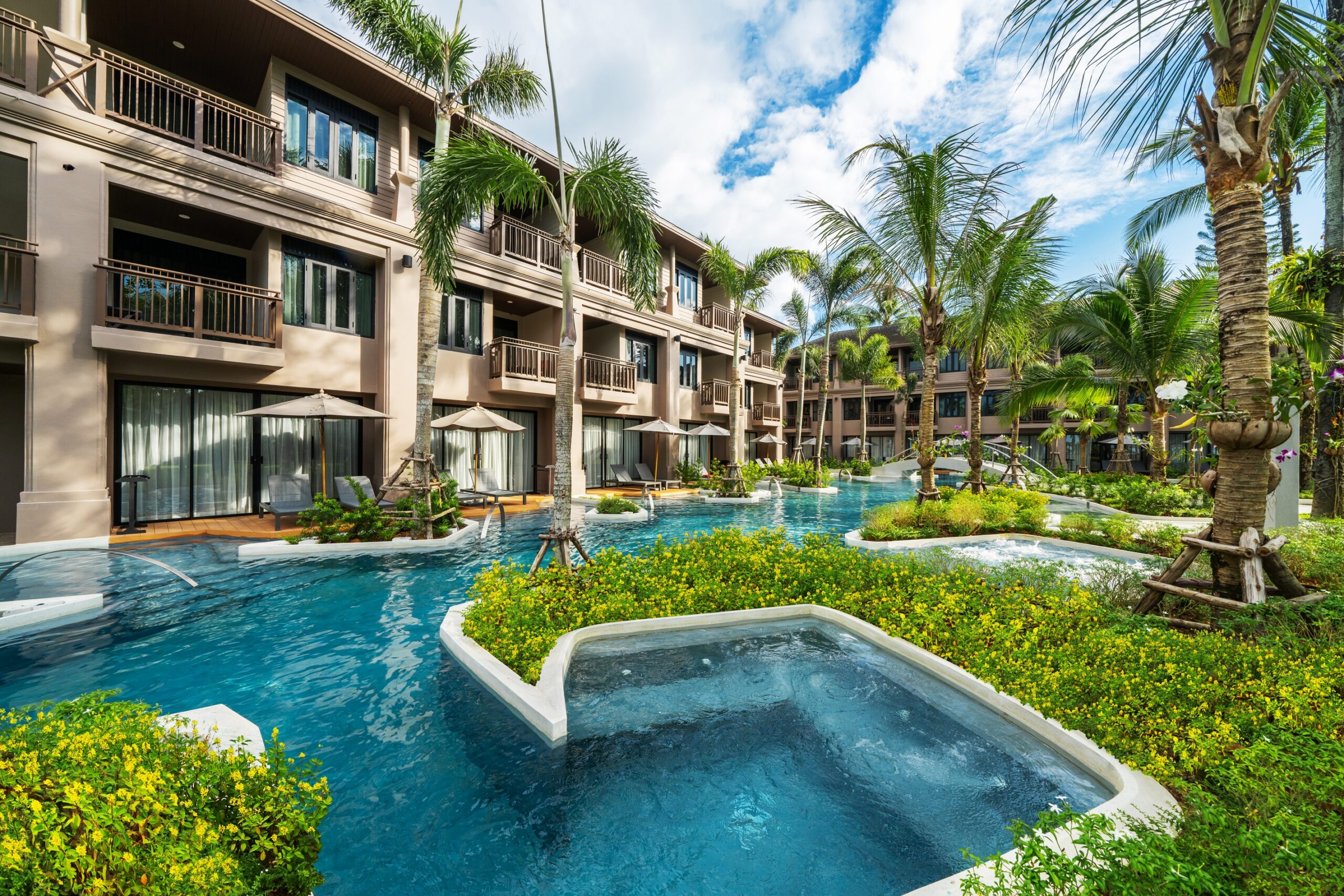 Lush greenery and connecting pools surround the rooms at La Flora Khao Lak