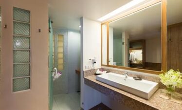 Modern bathroom at Katathani featuring a spacious vanity and walk in shower