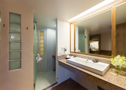 Modern bathroom at Katathani featuring a spacious vanity and walk in shower