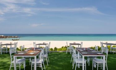 Oceanfront dining setup at Katathani with stunning beach and sea views