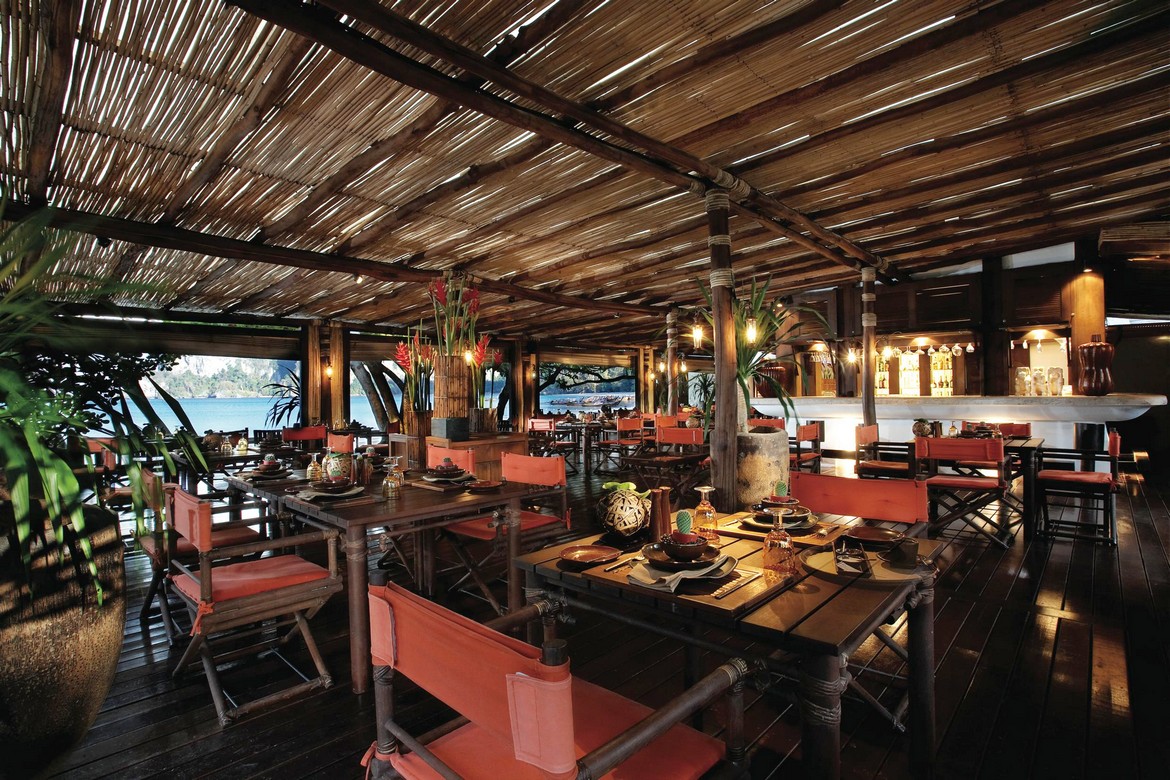 Outdoor restaurant at Rayavadee Krabi with wooden tables and chairs