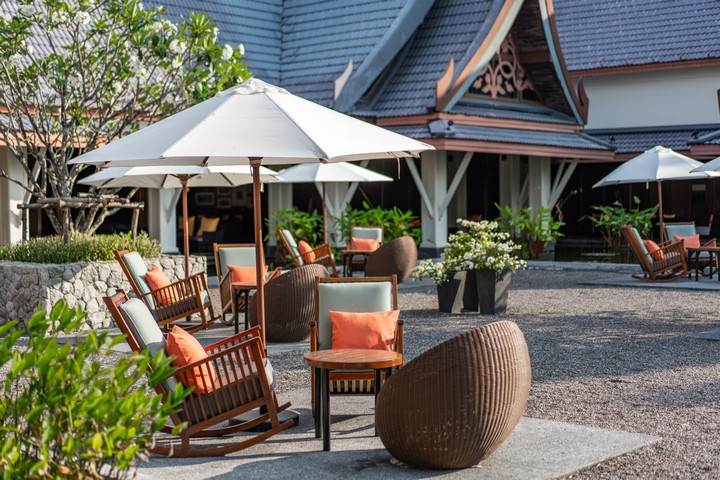 Outdoor seating area at Saii Laguna with cozy chairs and tropical decor