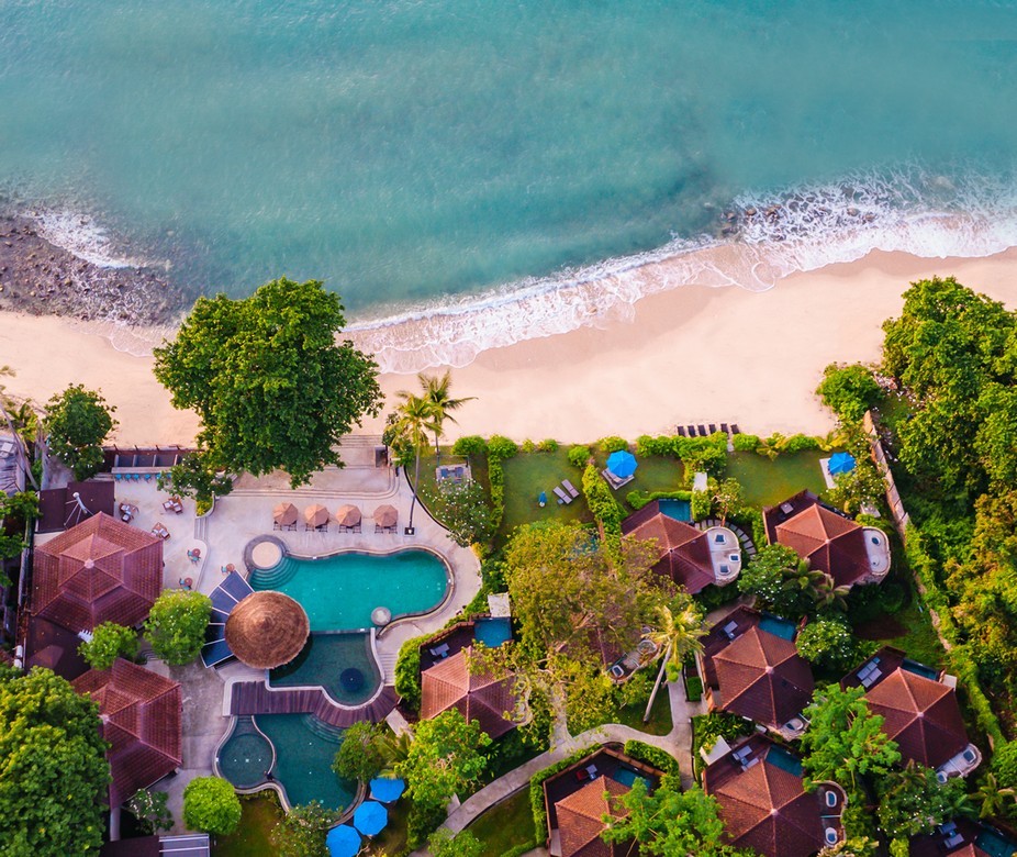 Overhead view of Saii Koh Samui resort with villas nestled among tropical greenery