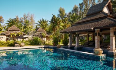 Pool area with surrounding greenery at Robinson Khao Lak