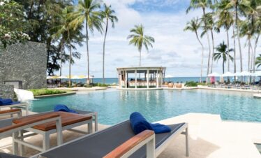 Pool loungers overlooking the Saii Laguna lagoon with ocean in the distance