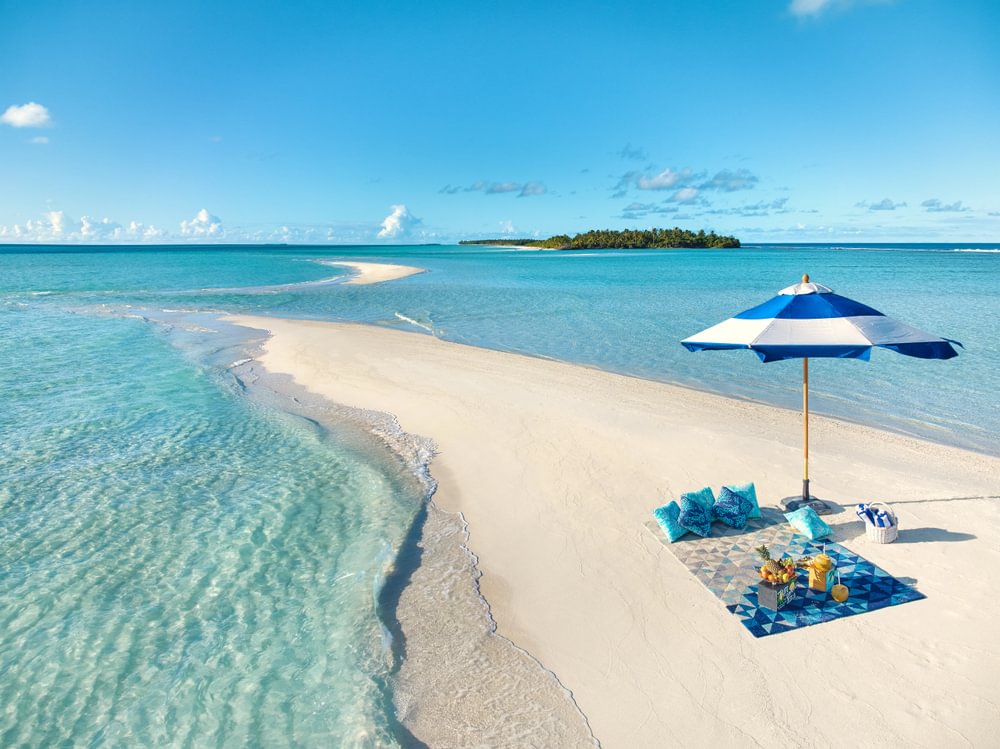 Private picnic setup on a Kandima sandbank by the ocean