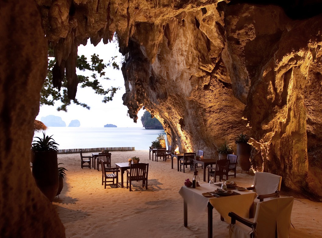Rayavadee Krabi restaurant in a cave with tables set on sandy beach overlooking the ocean