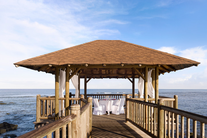 Romantic outdoor pavilion set for dining by the ocean at The Westin Turtle Bay Resort and Spa