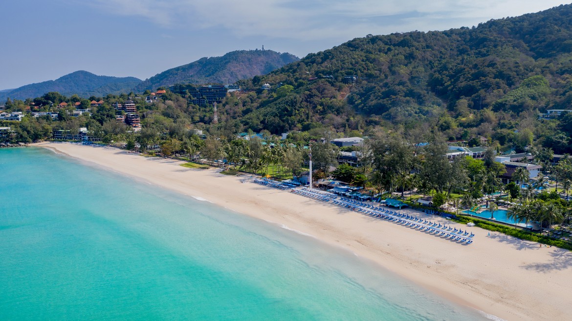 Serene aerial view of Katathani beach with lush green hills and clear waters