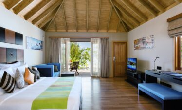 Spacious interior of Veligandu villa with tropical deck view