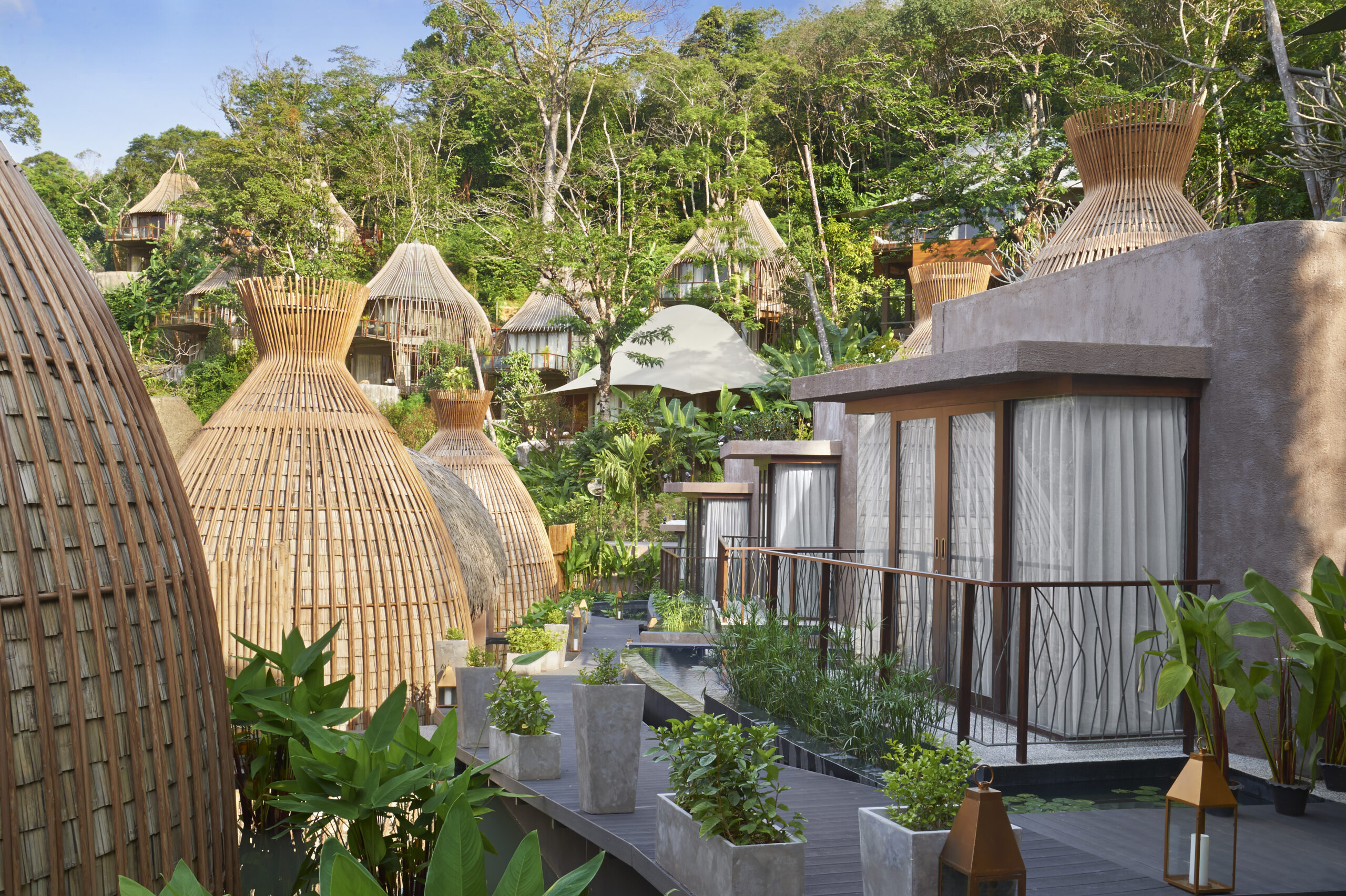 Unique clay cottages surrounded by tropical plants in the heart of Keemala resort