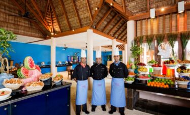 Veligandu chefs at buffet with colorful tropical fruit display