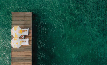 A serene overwater deck with sunbeds at Nirvana at Le Meridien Ile Mauritius