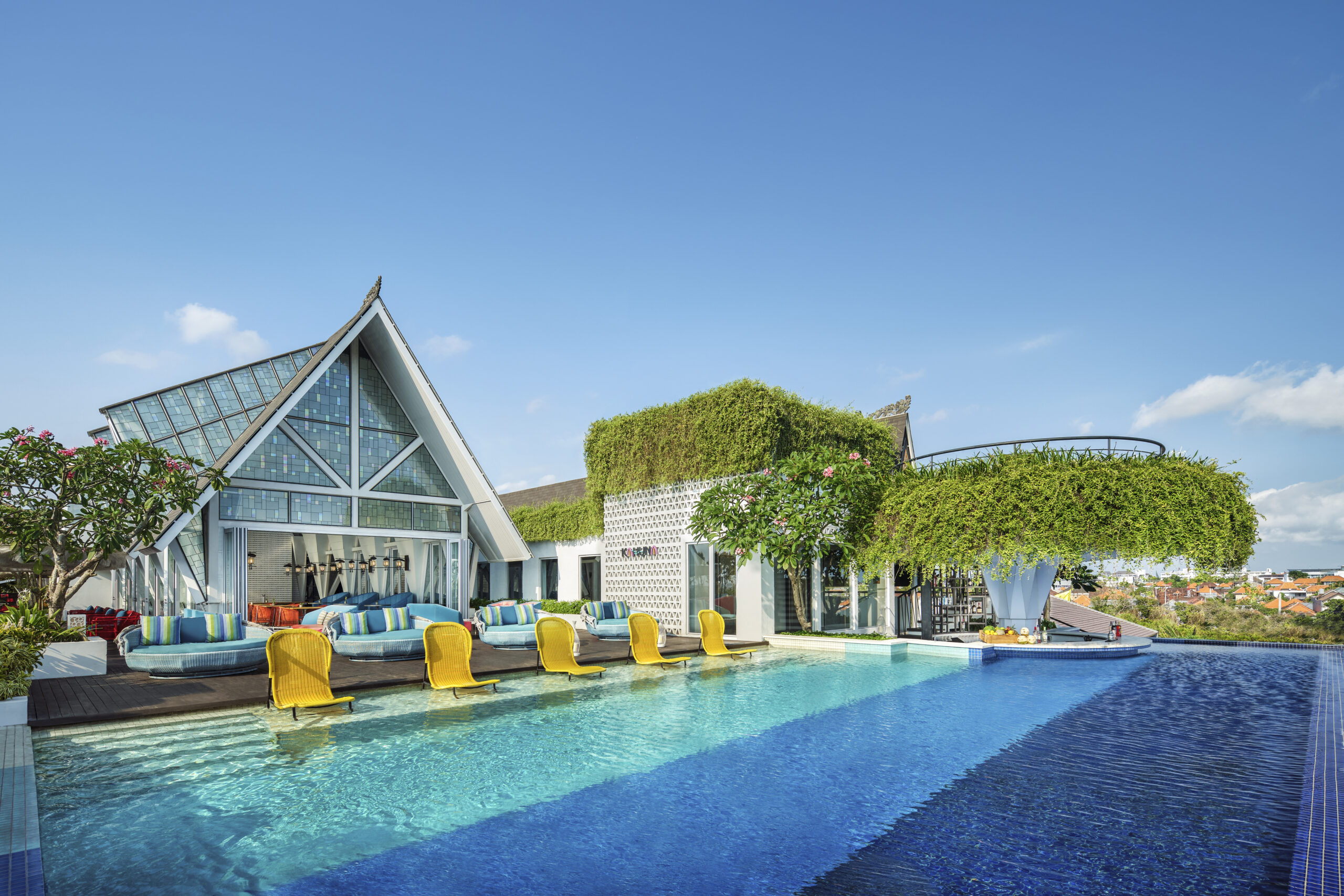 ALOFT BALI rooftop pool with modern loungers and city skyline views