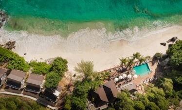 Aerial view of Carana Beach Hotel by the turquoise ocean