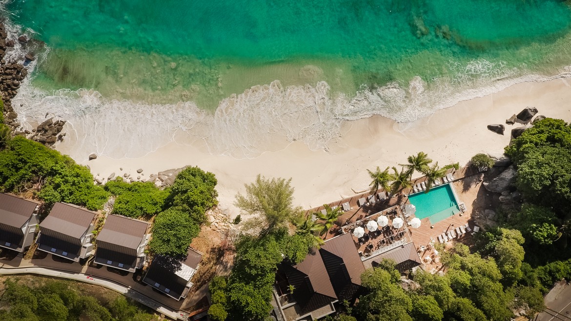 Aerial view of Carana Beach Hotel by the turquoise ocean