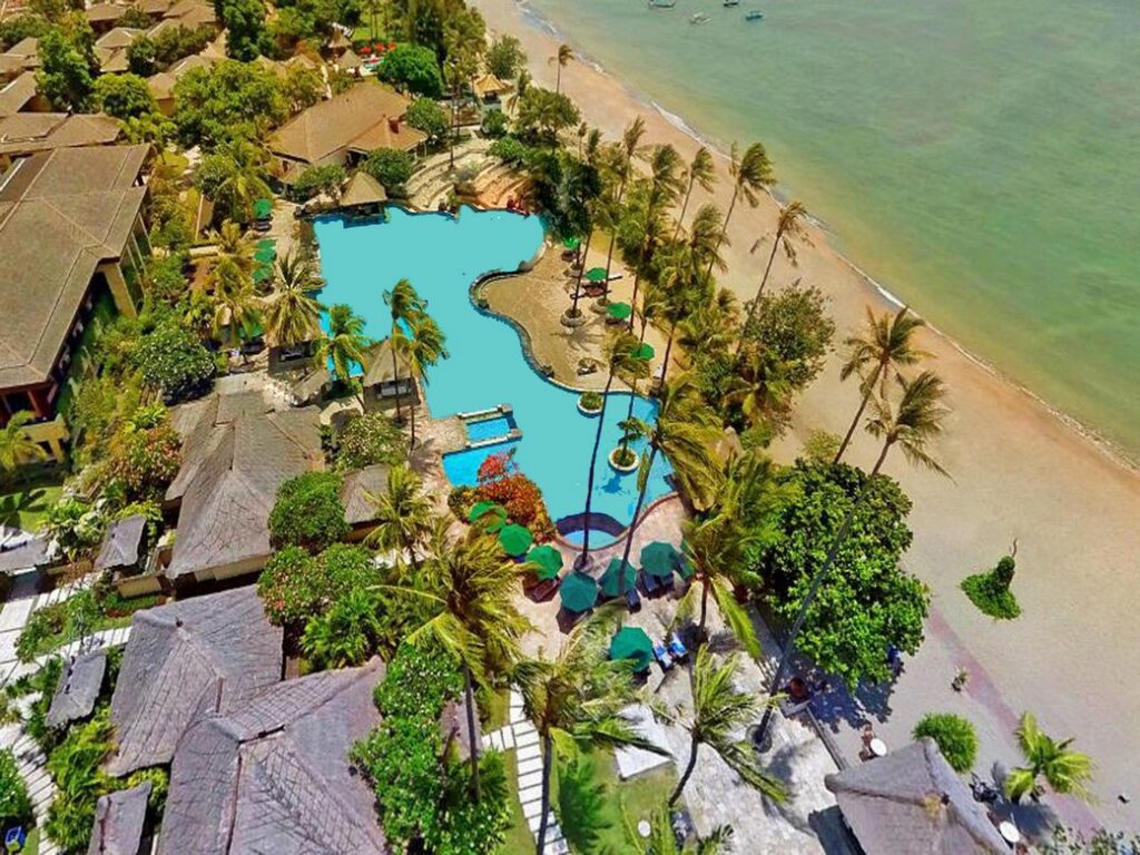 Aerial view of Patra Bali Resort and Villas with beachfront and lush gardens
