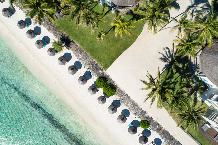 Aerial view of Solana Beach sunbeds and umbrellas lined along the pristine sandy shoreline