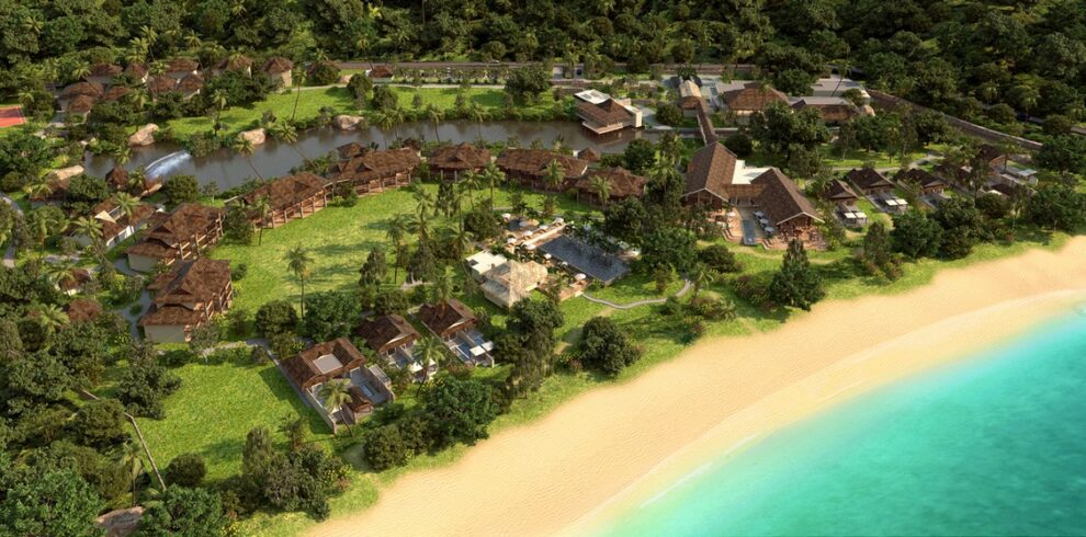 Aerial view of a tropical resort by the beach featuring lush greenery Story of serene natural beauty