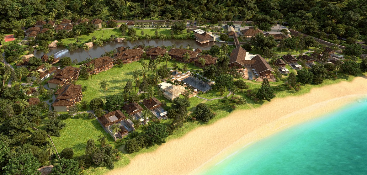 Aerial view of a tropical resort by the beach featuring lush greenery Story of serene natural beauty
