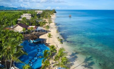 Aerial view of beach and resort pool at Nirvana At Le Meridien Ilse Mauritius showcasing crystal clear waters