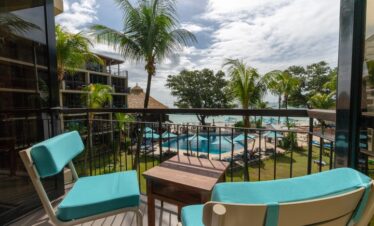 Balcony seating at Coral Strand Hotel Seychelles overlooking the pool