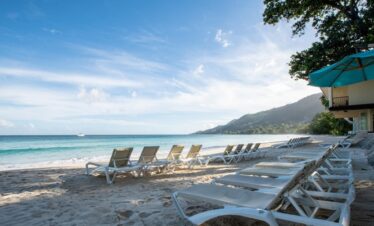 Beach loungers at Coral Strand Hotel Seychelles facing the ocean